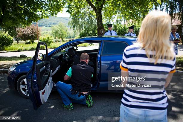 An officer of Bavaria police, with the attendance of officers of Czech police, checks a car while patrolling for crystal meth and other contraband...