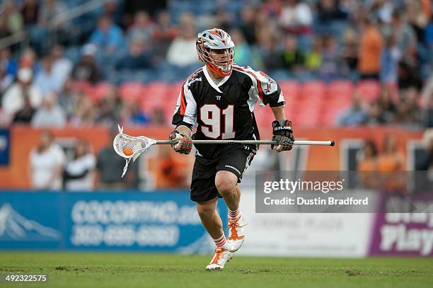 Dillon Roy of the Denver Outlaws carries the ball out of the defensive zone against the Rochester Rattlers during a Major League Lacrosse game at...