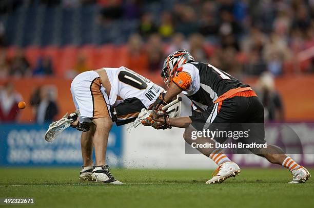 Justin Pennington of the Denver Outlaws wins a face-off by pushing the ball between the legs of John Ortolani of the Rochester Rattlers during a...