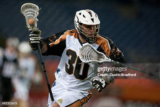 John Ortolani of the Rochester Rattlers carries the ball against the Denver Outlaws during a Major League Lacrosse game at Sports Authority Field at...