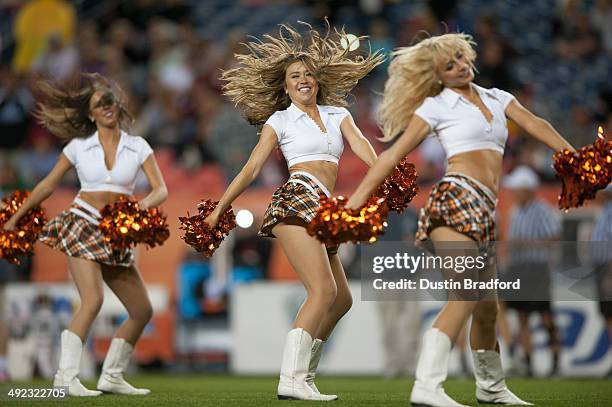 Denver Outlaws cheerleaders perform between quarters during a Major League Lacrosse game against the Rochester Rattlers at Sports Authority Field at...