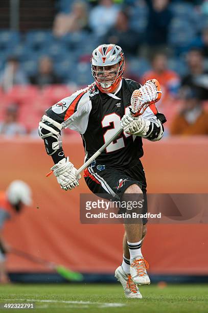 John Grant, Jr. #24 of the Denver Outlaws carries the ball against the Rochester Rattlers during a Major League Lacrosse game at Sports Authority...