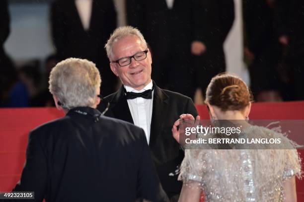 General Delegate of the Cannes Film Festival Thierry Fremaux gestures towards Canadian director David Cronenberg and US actress Julianne Moore as...