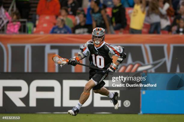 Chris Bocklet of the Denver Outlaws carries the ball against the Rochester Rattlers during a Major League Lacrosse game at Sports Authority Field at...