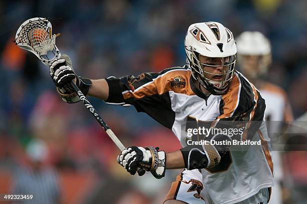 Kyle Denhoff of the Rochester Rattlers carries the ball against the Denver Outlaws during a Major League Lacrosse game at Sports Authority Field at...