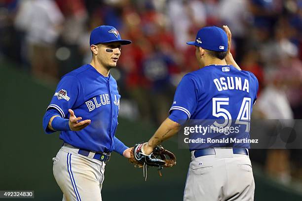 Troy Tulowitzki and Roberto Osuna of the Toronto Blue Jays celebrate after defeating the Texas Rangers in game three of the American League Division...