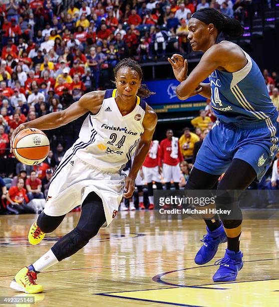 Tamika Catchings of the Indiana Fever dribbles the ball around Sylvia Fowles of the Minnesota Lynx at Bankers Life Fieldhouse on October 11, 2015 in...