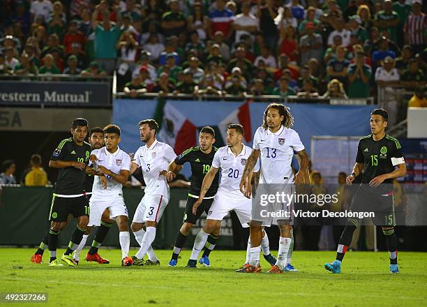 Jesus Corona, Carlos Salcido, Oribe Peralta and Hector Moreno of Mexico vie for position with DeAndre Yedlin, Brad Evans, Geoff Cameron and Jermaine...