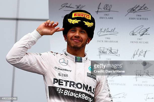 Lewis Hamilton of Great Britain and Mercedes GP celebrates on the podium after winning the Formula One Grand Prix of Russia at Sochi Autodrom on...