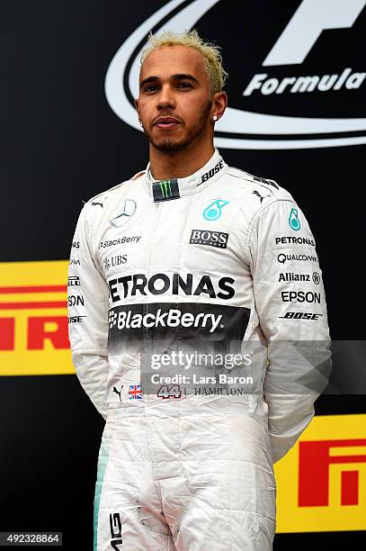 Lewis Hamilton of Great Britain and Mercedes GP celebrates on the podium after winning the Formula One Grand Prix of Russia at Sochi Autodrom on...