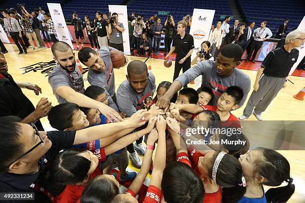 Chris Paul, Pablo Prigioni and C.J. Wilcox of the Los Angeles Clippers interacts with the kids during a NBA Cares clinic as part of the 2015 NBA...