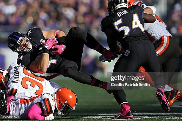 Baltimore Ravens fullback Kyle Juszczyk is tackled by Cleveland Browns defensive back K'Waun Williams in the second half at M&T Bank Stadium on...