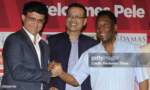 Brazilian football legend Pele poses during a photocall with former Indian cricketer and Atletico De Kolkata Co-owner, Sourav Ganguly and Atletico De...
