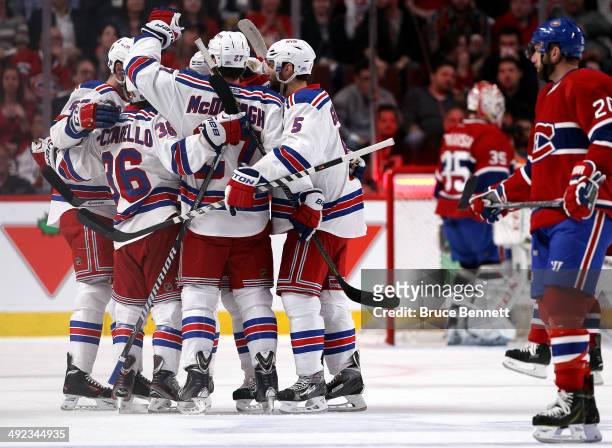 Ryan McDonagh of the New York Rangers celebrates with his teammates after scoring a goal against Dustin Tokarski of the Montreal Canadiens during the...