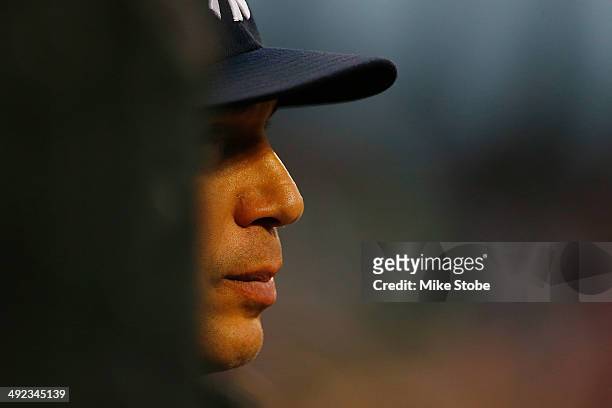 Joe Girardi of the New York Yankees looks on from the dugout in the second inning against the New York Mets on May 15, 2014 at Citi Field in the...