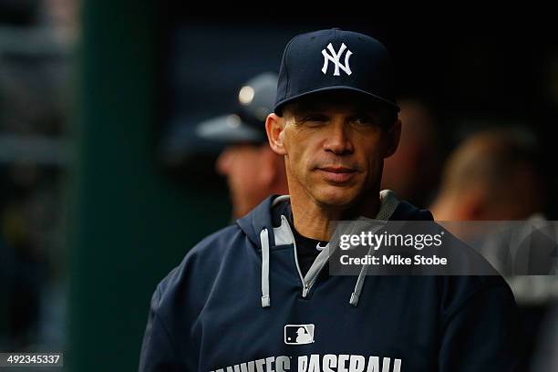Joe Girardi of the New York Yankees looks on from the dugout prior to the game against the New York Mets on May 15, 2014 at Citi Field in the...
