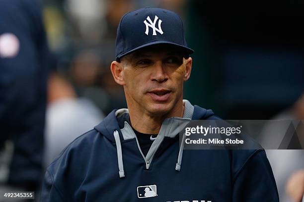 Joe Girardi of the New York Yankees looks on from the dugout prior to the game against the New York Mets on May 15, 2014 at Citi Field in the...