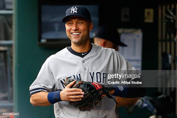 Derek Jeter of the New York Yankees looks on from the dugout prior to the game against the New York Mets on May 15, 2014 at Citi Field in the...