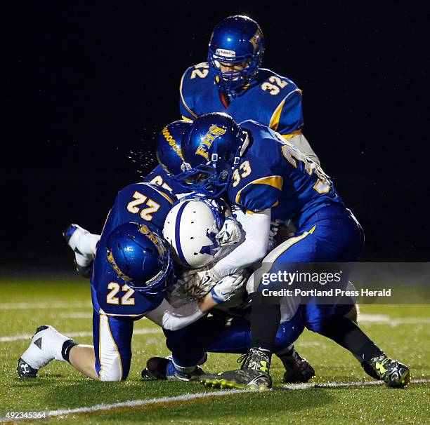 Falmouth vs Morse football. Falmouth players combine to stop Dillion Havener of Morse on a kick return during the first quarter. Contributing on the...