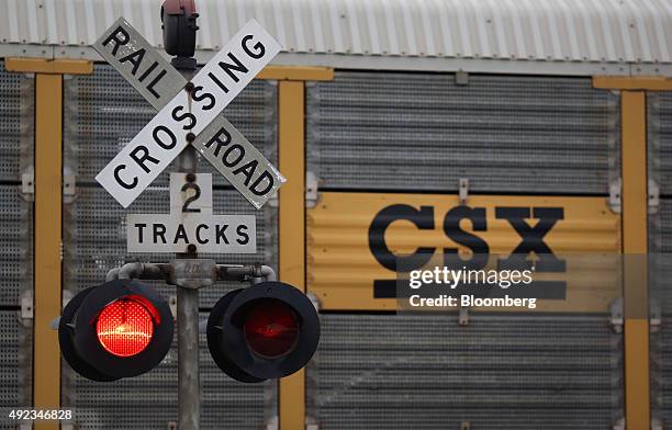 Southbound CSX Corp. Auto rack freight train passes a grade crossing signal in La Grange, Kentucky, U.S., on Thursday, Oct. 1, 2015. CSX Corp. Is...
