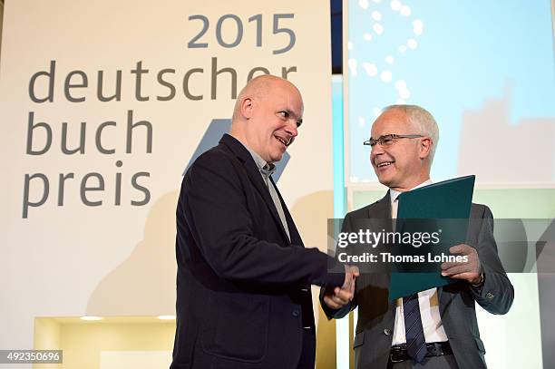 The chairman of the German Book Trade Association Heinrich Riethmueller arwards Novelist Frank Witzel with the German Book Prize 2015 at city hall...