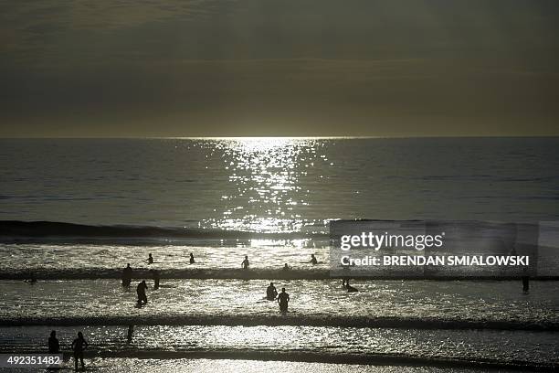 People swim in the Pacific Ocean off Del Mar beach October 11, 2015 in La Jolla, California. Temperatures continue to be steady in La Jolla, southern...