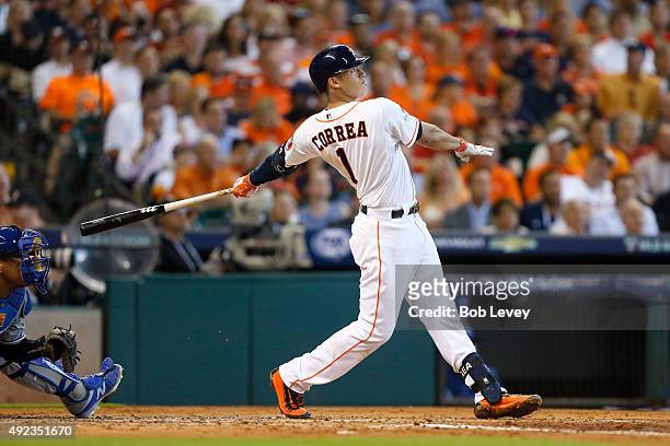 Carlos Correa of the Houston Astros hits a solo home run to tie the game in the third inning against the Kansas City Royals during game four of the...