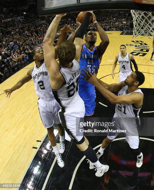 Kevin Durant of the Oklahoma City Thunder goes up for a shot against Kawhi Leonard, Tiago Splitter and Tim Duncan of the San Antonio Spurs in the...