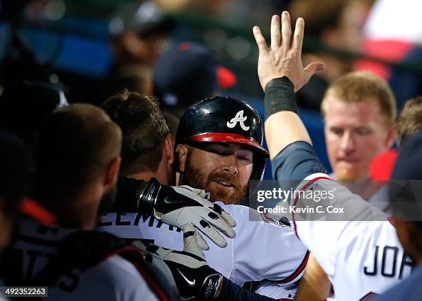 Ryan Doumit of the Atlanta Braves hugs Freddie Freeman after hitting a solo homer in the eighth inning against the Milwaukee Brewers at Turner Field...