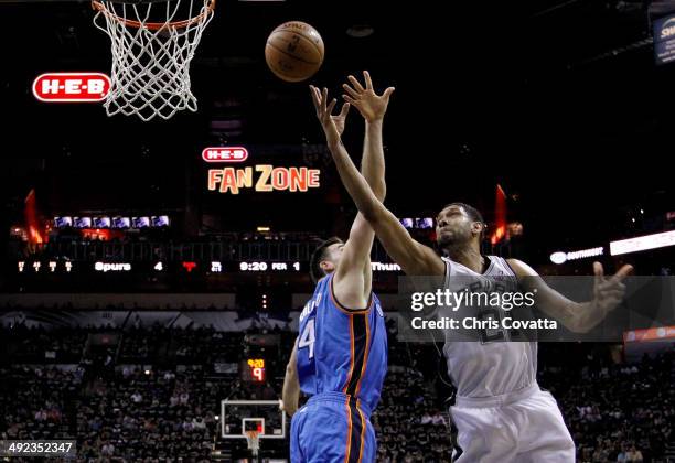Tim Duncan of the San Antonio Spurs goes up for a shot against Nick Collison of the Oklahoma City Thunder in the first half in Game One of the...