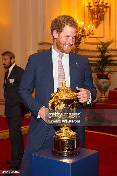 Prince Harry with the Webb Ellis Trophy at a reception at Buckingham Palace on October 12, 2015 in London, United Kingdom.