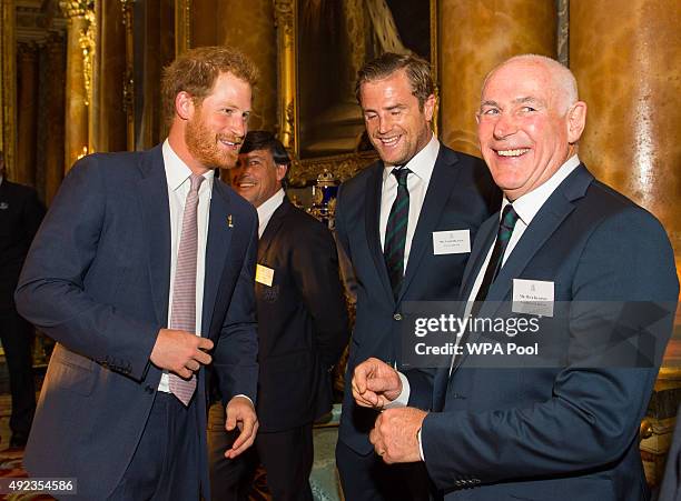 Prince Harry speaks to Ireland Rugby Union player Jamie Heaslip and Ireland head coach Mick Kearney at a Rugby World Cup reception at Buckingham...