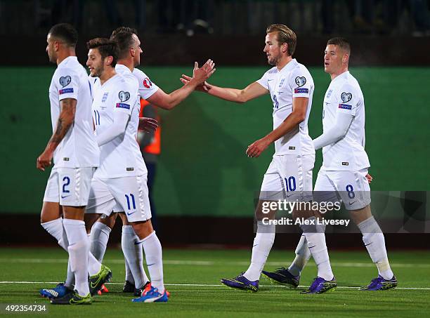 Harry Kane of England celebrates with team mates as his shot rebounds off goalkeeper Giedrius Arlauskis of Lithuania for an own goal and England's...