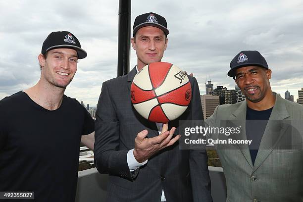 Basketballer Mark Worthington poses with Chris Anstey and Darryl McDonald the coaches of United during the Melbourne United NBL press conference at...