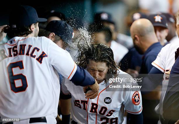 Colby Rasmus of the Houston Astros celebrates his seventh inning solo home run as Jake Marisnick throws water on him against the Kansas City Royals...