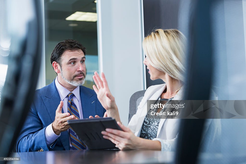 Woman using digtal tablet in business meeting