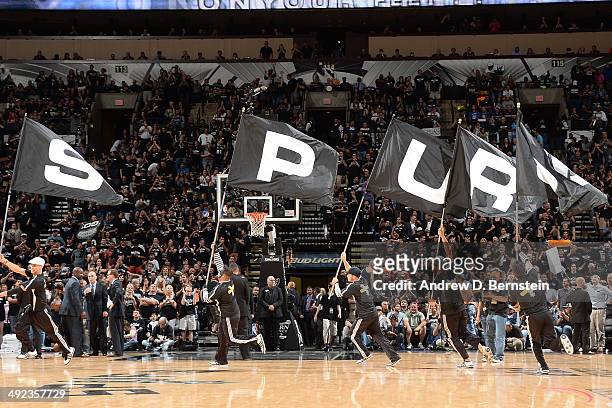 Members of the San Antonio Spurs cheer squad run onto the court with the Spurs Logo during a timeout against the Oklahoma City Thunder during Game...