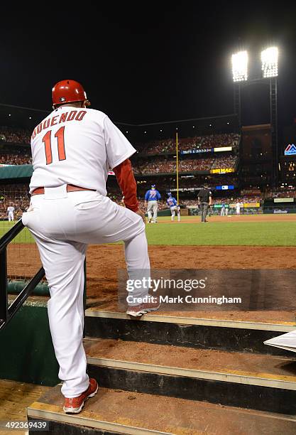 Third base coach Jose Oquendo of the St. Louis Cardinals looks on from the dugout during the game against the Chicago Cubs at Busch Stadium on May...