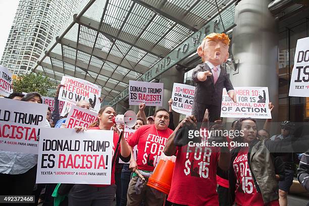 Demonstrators hold up a piñata of Republican Presidential candidate Donald Trump during a protest outside Trump Tower on October 12, 2015 in Chicago,...