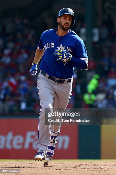 Chris Colabello of the Toronto Blue Jays rounds the bases after hitting a solo home run in the first inning against the Texas Rangers in game four of...