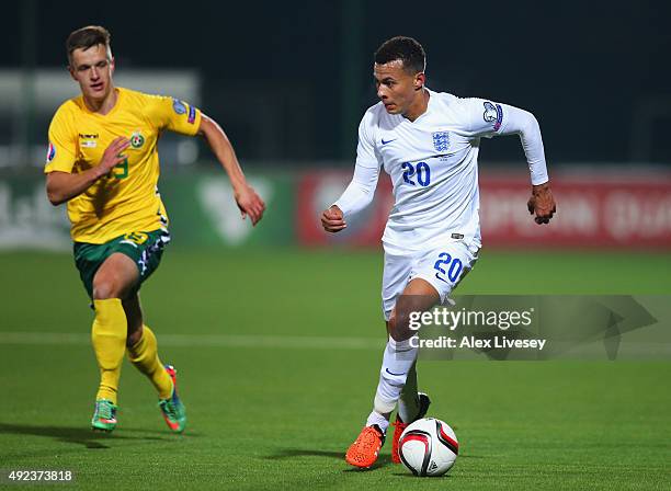 Dele Alli of England is chased by Deimantas Petravicius of Lithuania during the UEFA EURO 2016 qualifying Group E match between Lithuania and England...