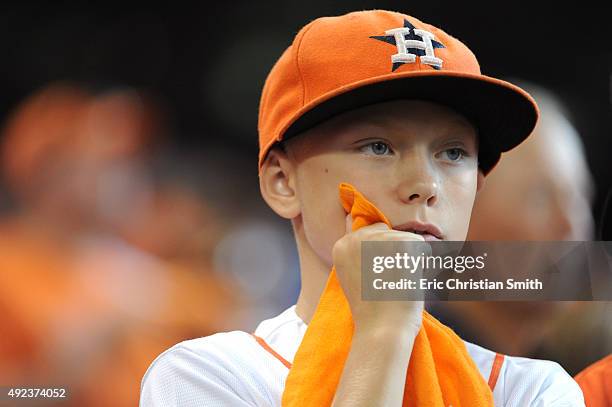 Young Houston Astros fan looks on as his team loses the lead in the eighth inning against the Kansas City Royals during game four of the American...