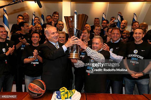 Israeli Prime Minister Benjamin Netanyahu holds the EuroLeague trophy with Maccabi Electra Tel Aviv President Shimon Mizrahi as head coach of Maccabi...
