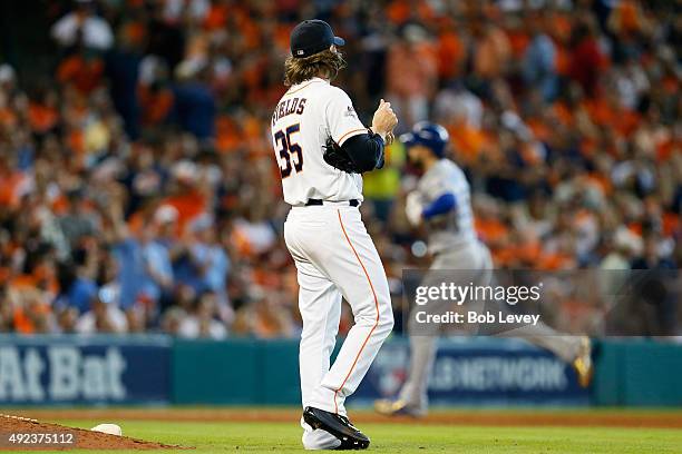 Josh Fields of the Houston Astros watches as Eric Hosmer of the Kansas City Royals rounds the bases after a two-run home run in the ninth inning...