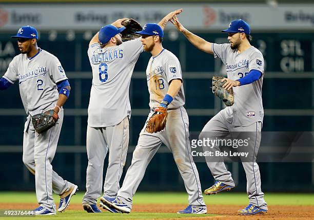 Alcides Escobar, Mike Moustakas, Ben Zobrist and Eric Hosmer of the Kansas City Royals celebrate after defeating the Houston Astros during game four...