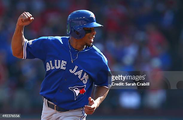 Ben Revere of the Toronto Blue Jays celebrates as he rounds the bases to score on Josh Donaldson's home run in the top of the first inning of Game 4...