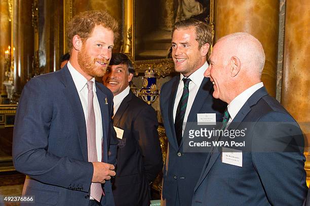 Prince Harry speaks to Irish Rugby Union player Jamie Heaslip and Ireland head coach Mick Kearney at a Rugby World Cup reception at Buckingham Palace...
