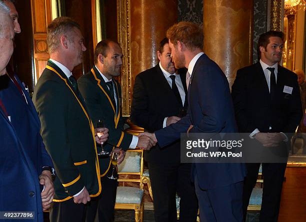 Queen Elizabeth II shakes hands with South Africa's Rugby Union Captain Fourie du Preez at a reception at Buckingham Palace to welcome Rugby World...