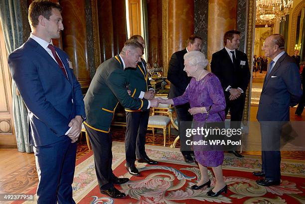 Queen Elizabeth II meets South Africa's Rugby Union head coach Heyneke Meyer at a reception at Buckingham Palace to welcome Rugby World Cup stars on...