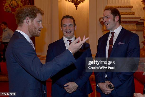 Prince Harry meets Welsh Rugby Union player Gethin Jenkins and Alun-Wyn Jones during a Rugby World Cup reception at Buckingham Palace on October 12,...